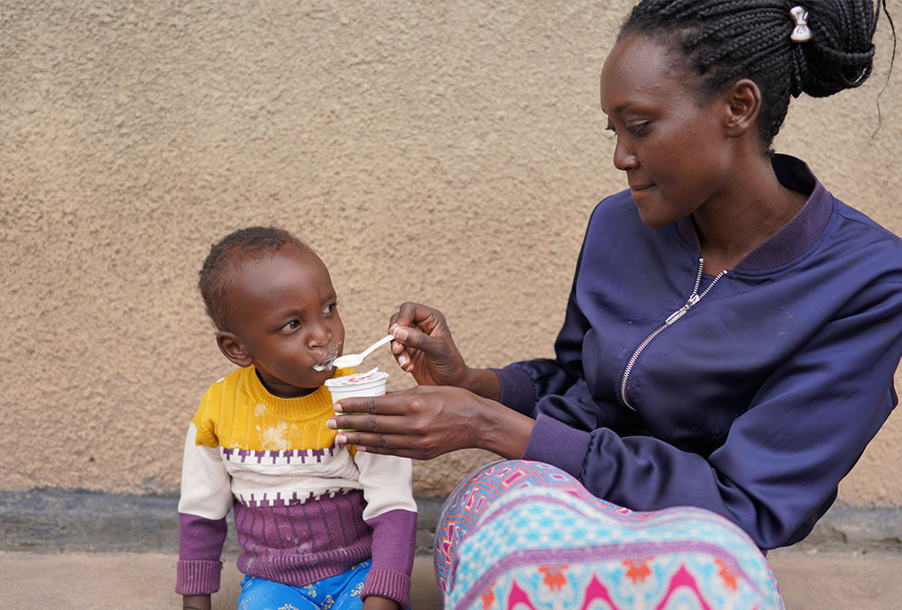 Kellen feeding Eric after cleft surgery