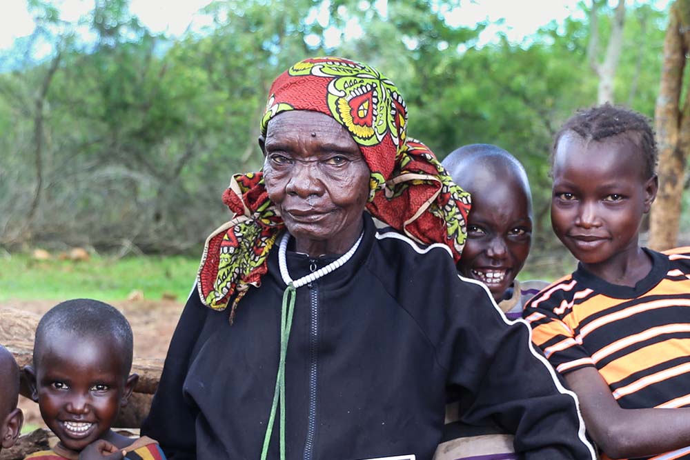 Maria smiling with her grandchildren after cleft surgery