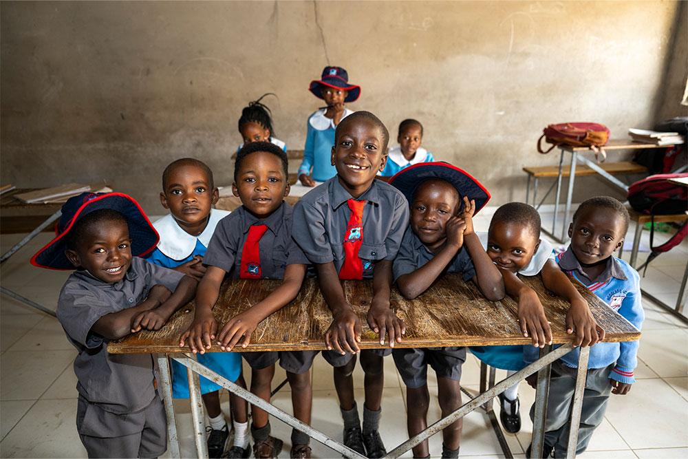 David smiling with his classmates after cleft surgery