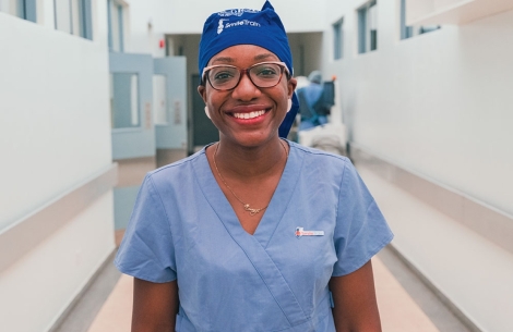 Dr. Elizabeth Igaga smiling in scrubs