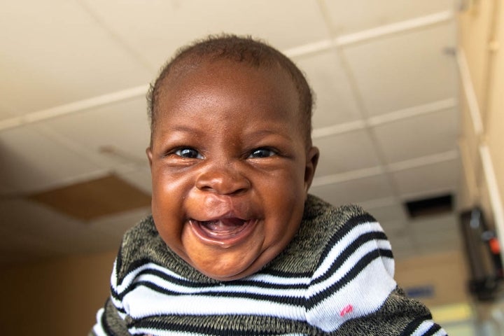 Boy laughs at camera