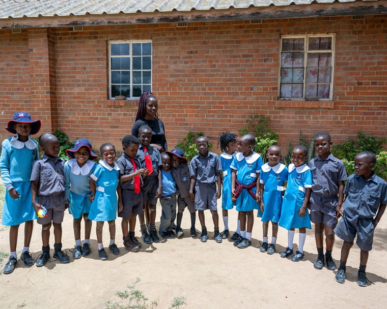 David smiling with his classmates after cleft surgery