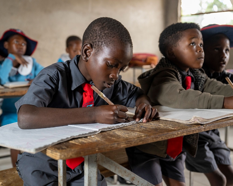 David studying in school after cleft surgery