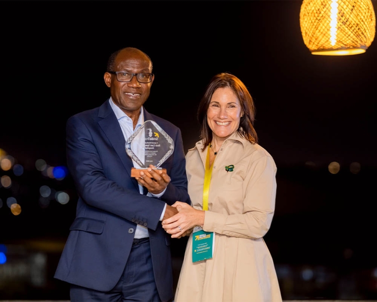 Dr Georges Ntakiyiruta receiving a partner recognition award from Smile Train CEO Susannah Schaefer