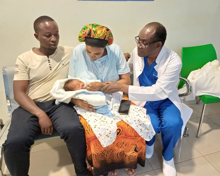 Dr Georges Ntariyiruka visiting with parents and patient before cleft surgery at Best care specialist hospital Rwa