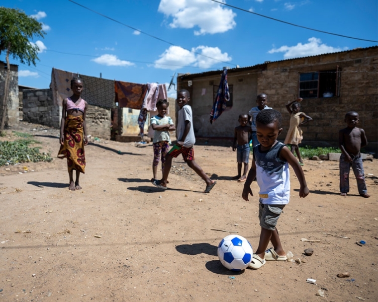 Joshua playing with a soccer ball