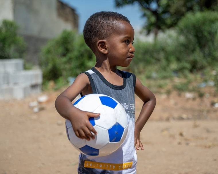 Joshua holding a soccer ball