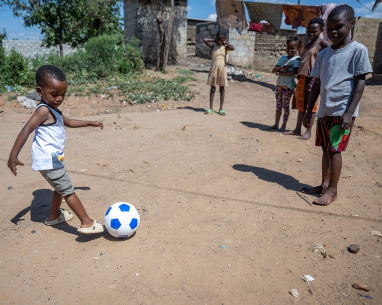 Joshua kicking a soccer ball